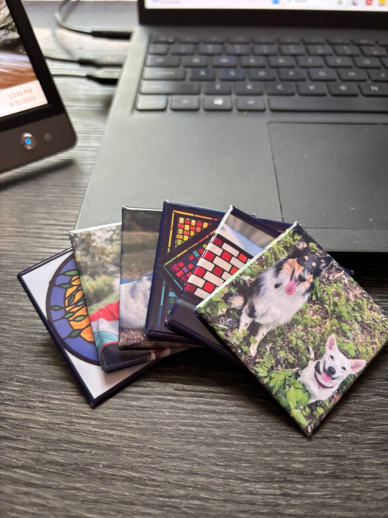 Display of 6 2inx2in photo magnets leaned against the keyboard of a laptop.